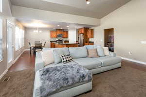 Living room featuring dark wood-type flooring and a chandelier