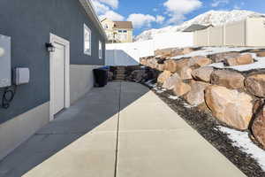 Snow covered patio with a mountain view