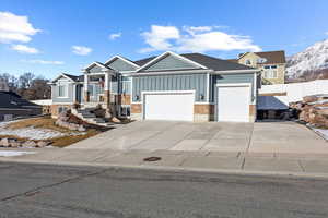 View of front of house featuring a mountain view and a garage