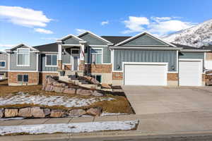 View of front of property with a mountain view and a garage