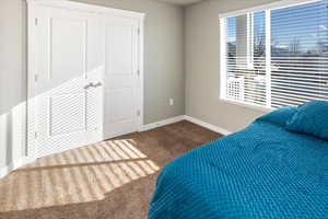 Unfurnished bedroom featuring a closet and carpet floors