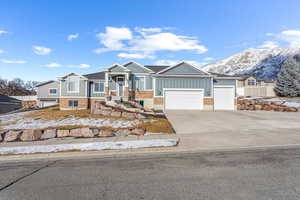 View of front of home featuring a mountain view and a garage