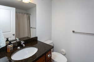 Bathroom featuring vanity and toilet