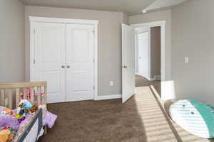 Carpeted bedroom featuring a closet