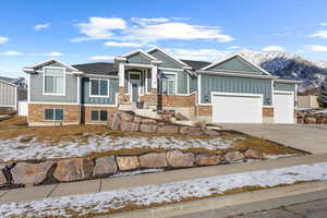 View of front of home with a mountain view and a garage