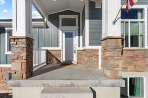 View of exterior entry with covered porch