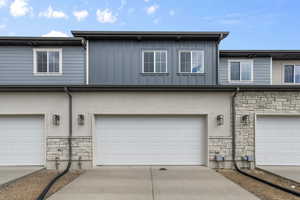 View of back of home with a garage