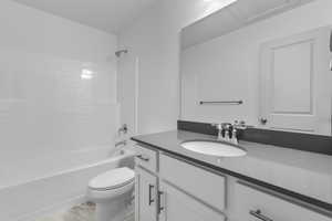 Full bathroom featuring bathing tub / shower combination, vanity, wood-type flooring, and toilet