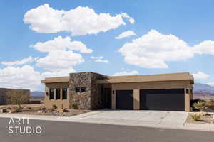 Adobe home featuring a mountain view and a garage