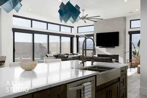 Kitchen featuring dark brown cabinetry, ceiling fan, dishwasher, and sink