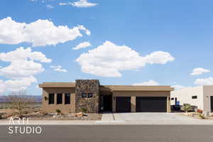 Pueblo-style home with a garage