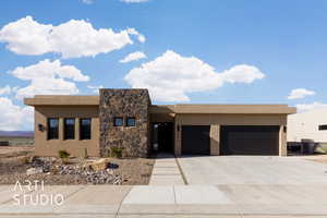 Pueblo-style house featuring a garage