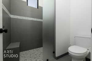 Bathroom with a tile shower and toilet