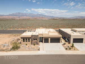 View of front of home featuring a mountain view and a garage