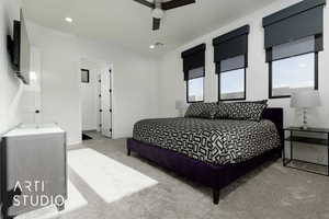 Carpeted bedroom featuring ceiling fan