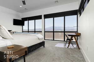 Carpeted bedroom featuring a mountain view and ceiling fan