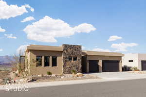 Pueblo-style house with central AC and a garage