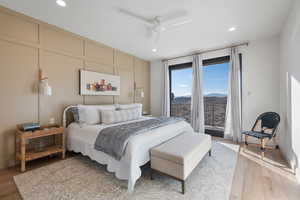 Bedroom with ceiling fan, a mountain view, access to outside, and light hardwood / wood-style flooring