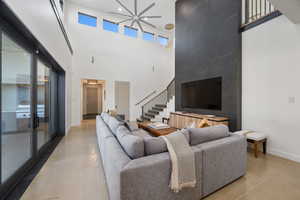 Living room featuring concrete flooring, french doors, and a towering ceiling