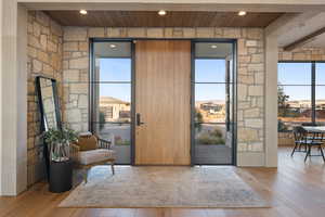 Entryway featuring beam ceiling, light hardwood / wood-style flooring, and wooden ceiling