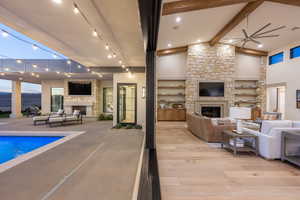 Interior space featuring a stone fireplace and ceiling fan