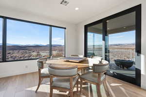 Dining space featuring a mountain view and light hardwood / wood-style floors