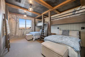 Bedroom featuring light carpet