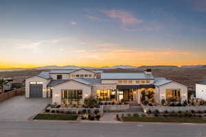 View of front of home with a mountain view and a garage