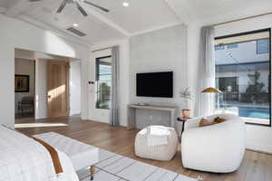 Bedroom featuring hardwood / wood-style floors, lofted ceiling with beams, ceiling fan, and wood ceiling