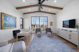 Office area with vaulted ceiling with beams, dark hardwood / wood-style floors, and ceiling fan