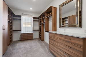 Spacious closet featuring light carpet