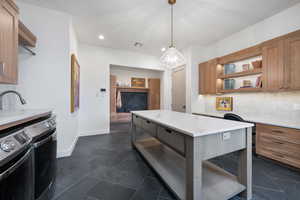 Kitchen with decorative light fixtures, independent washer and dryer, backsplash, and an inviting chandelier