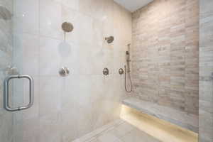 Bathroom with tile patterned floors and a shower with shower door