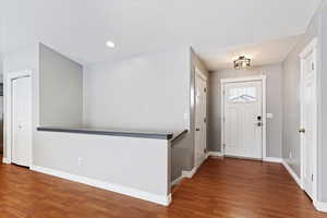 Entrance foyer with hardwood / wood-style flooring