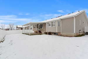 View of snow covered back of property