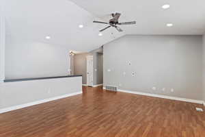 Unfurnished living room featuring hardwood / wood-style flooring, ceiling fan, and vaulted ceiling