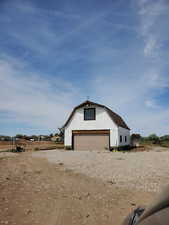 View of home's exterior with a garage and an outdoor structure