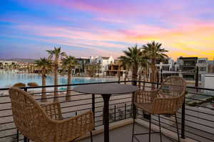 Balcony at dusk featuring a water view