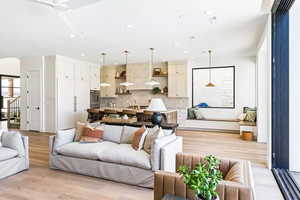 Living room with sink and light hardwood / wood-style floors