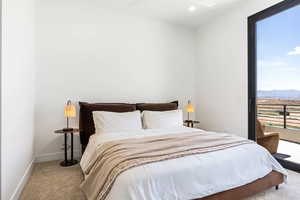 Bedroom featuring light carpet and a mountain view