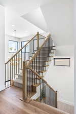 Staircase featuring wood-type flooring