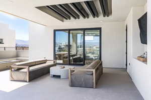 Living room featuring a mountain view and a raised ceiling