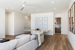 Living room with hardwood / wood-style floors and ceiling fan