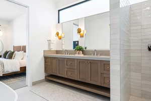 Bathroom featuring vanity and shower with separate bathtub