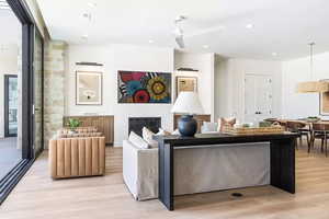 Living room featuring light hardwood / wood-style flooring and ceiling fan