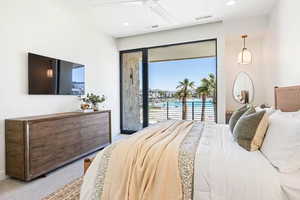 Bedroom featuring carpet, ceiling fan, and a water view