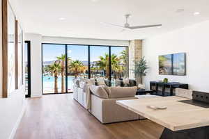 Living room with ceiling fan and light wood-type flooring