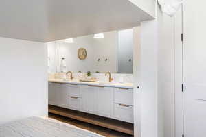 Bathroom with hardwood / wood-style floors and vanity