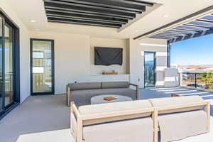 View of patio featuring outdoor lounge area and a balcony