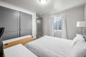 Bedroom with dark carpet and a closet